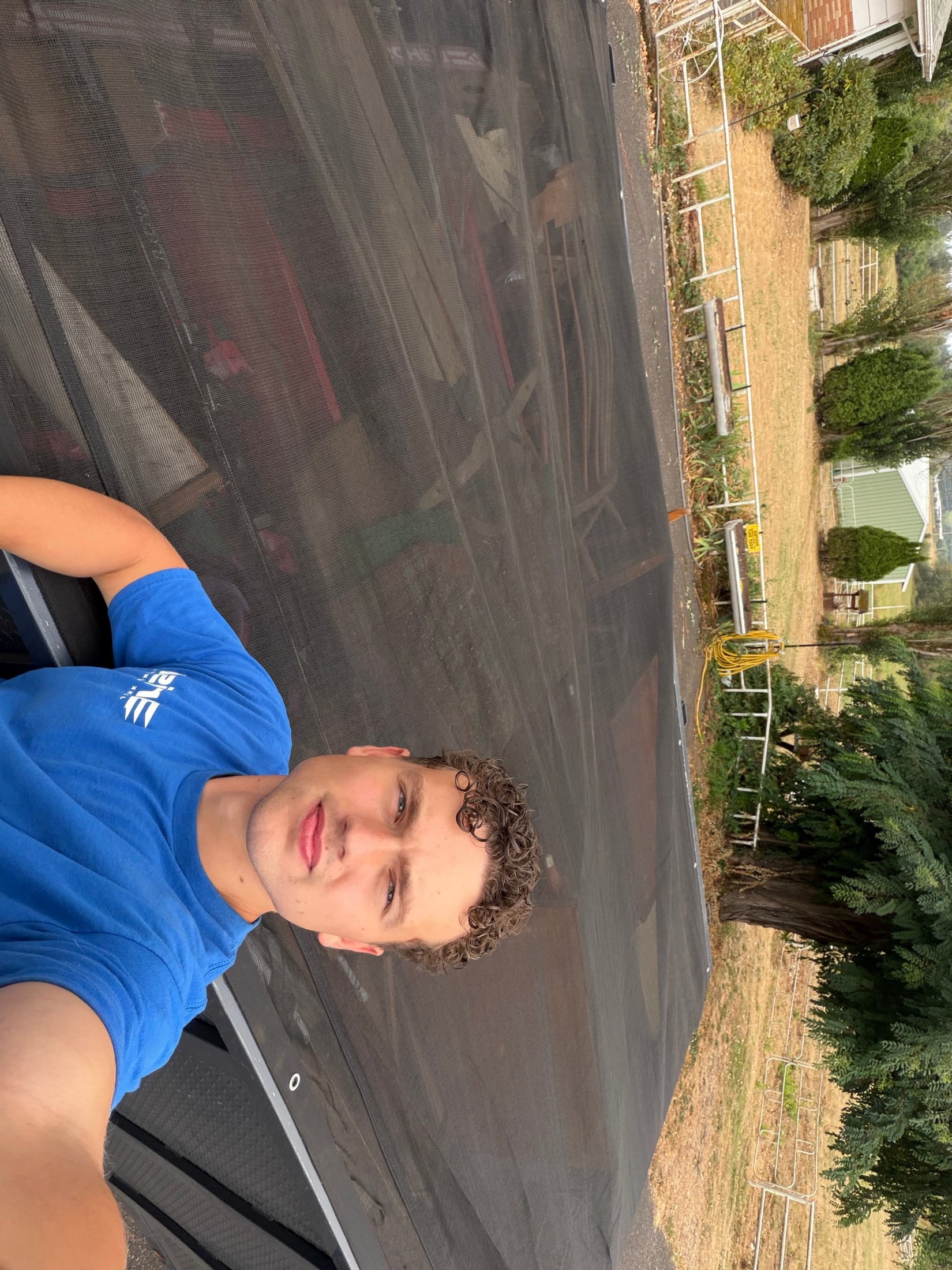 Brisk Junk Removal crew member with a trailer loaded full of hauled-away junk at a local property