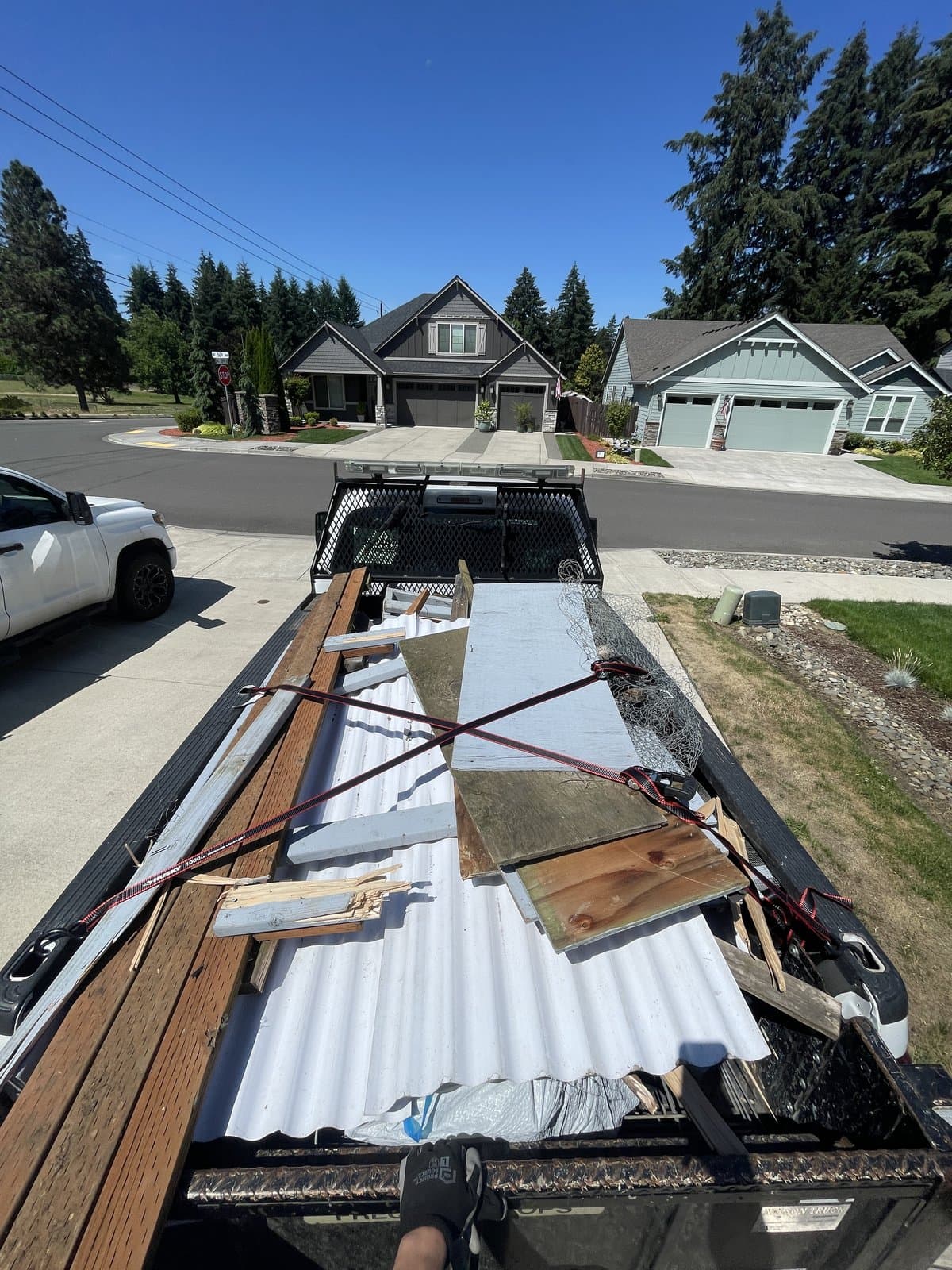 A full load of demolition debris strapped down in the Brisk dump trailer
