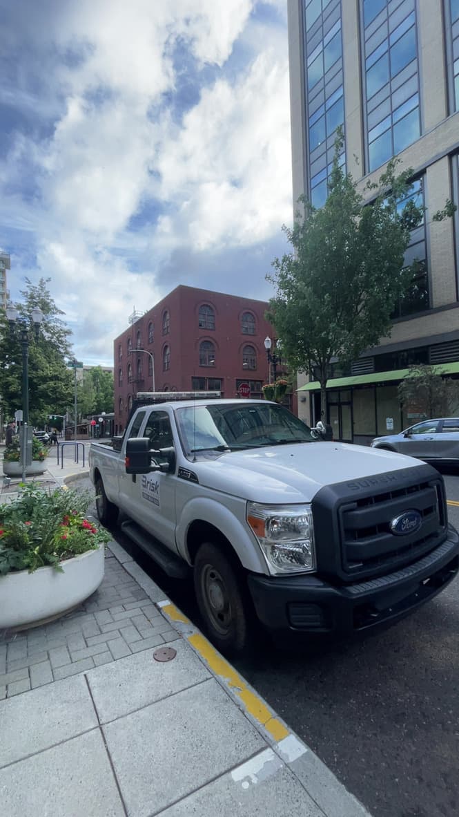 Brisk Junk Removal's first truck parked on a downtown Portland street during a job